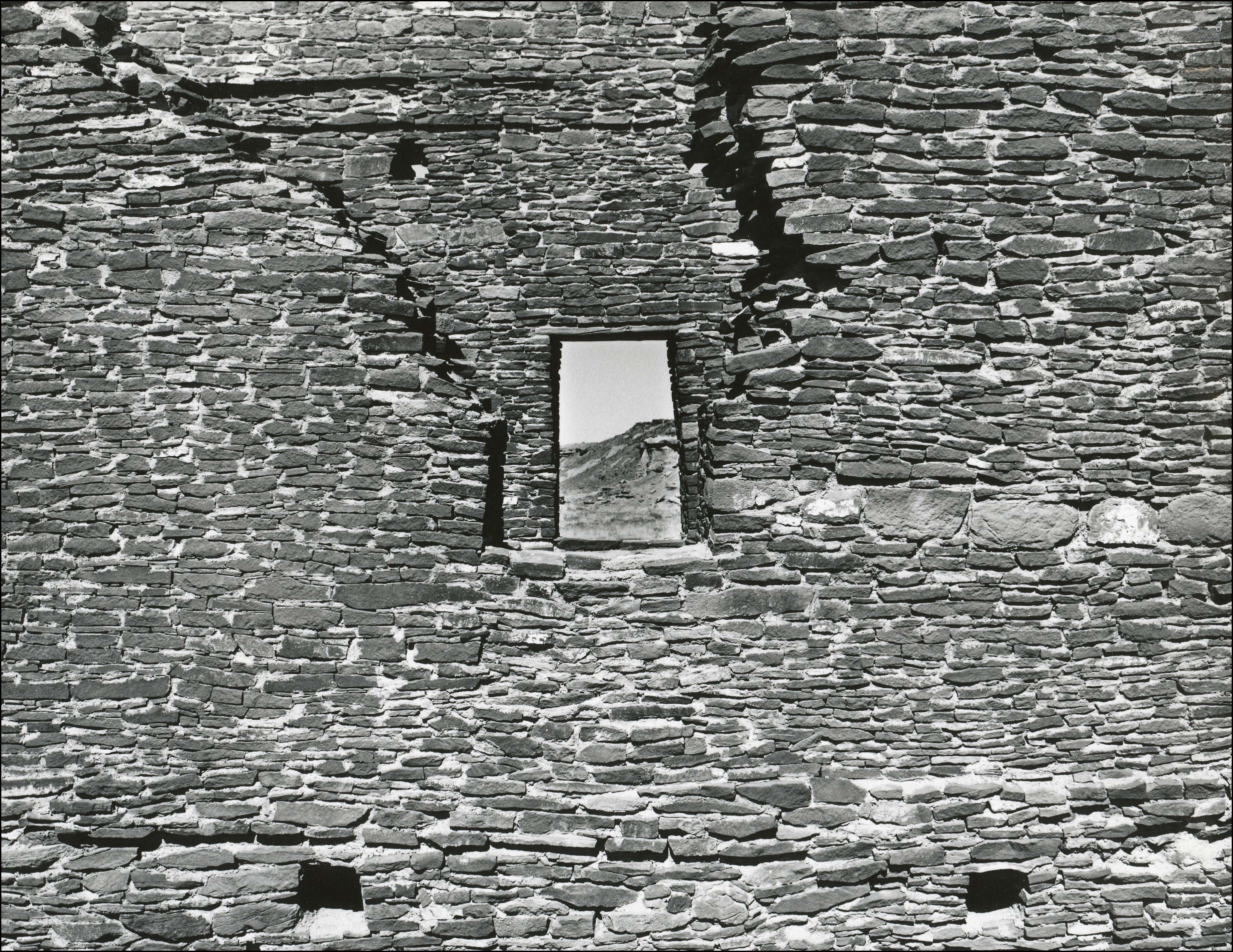 Looking through a small window in an old pueblo wall