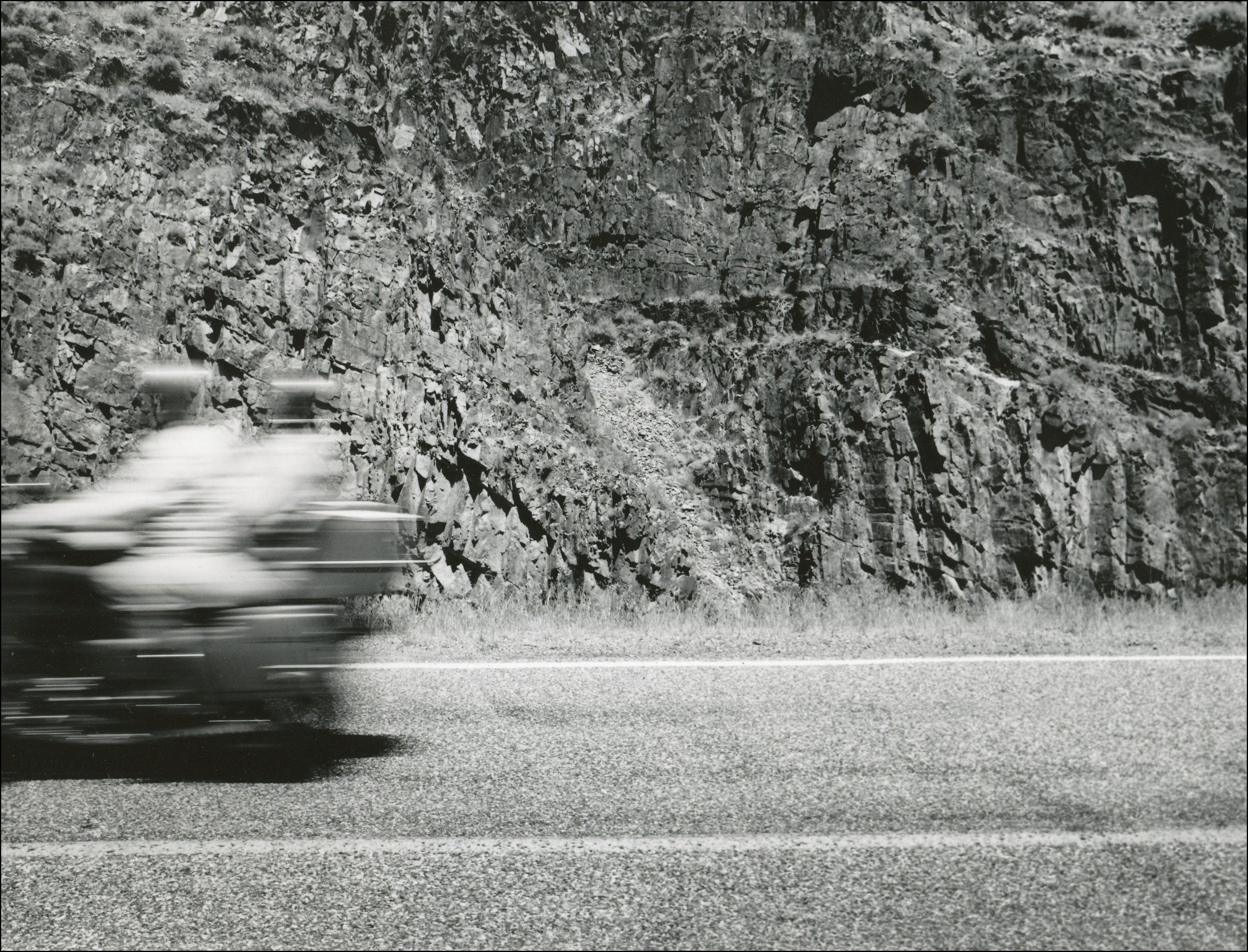 Blurred motorcycle with two riders on highway